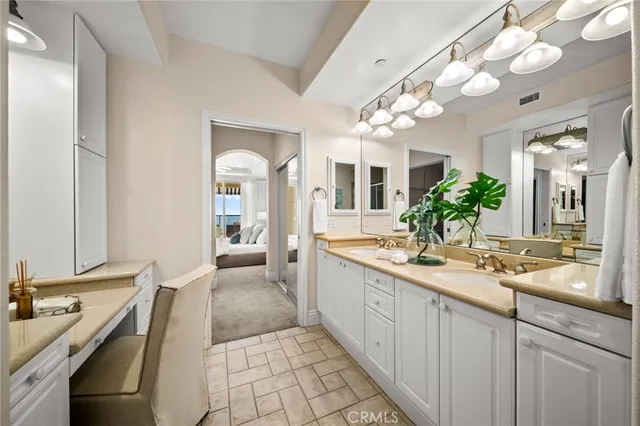 a bedroom with a bed a chair and a potted plant