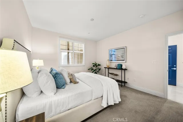 a bedroom with a bed and a lamp