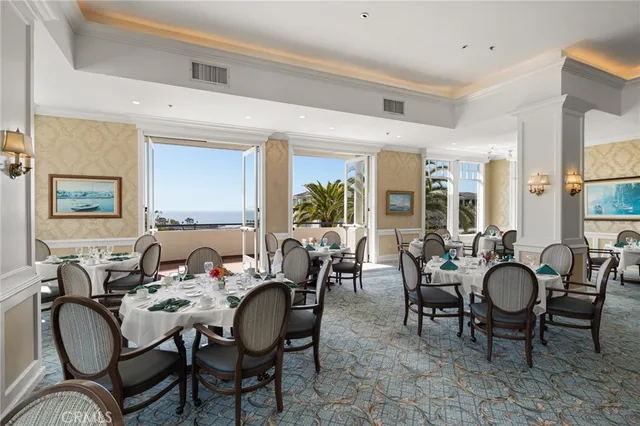 a large hall with chairs and view of living room
