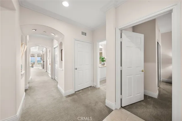 a view of a hallway with wooden shelves