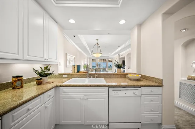 a kitchen with sink and cabinets