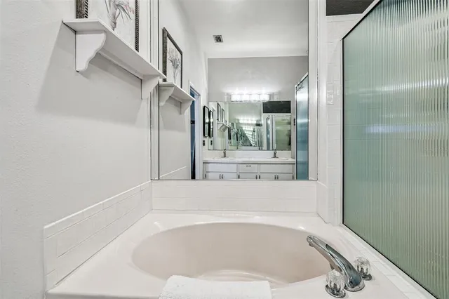 a bedroom with a bed and a ceiling fan