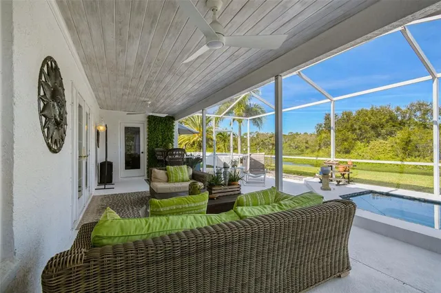 a view of a patio with table and chairs with wooden floor and plants
