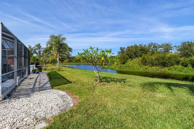 a view of backyard with swimming pool and green space
