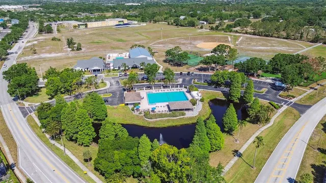 an aerial view of a house with garden space and sitting area