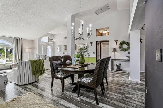 a kitchen with cabinets and wooden floor