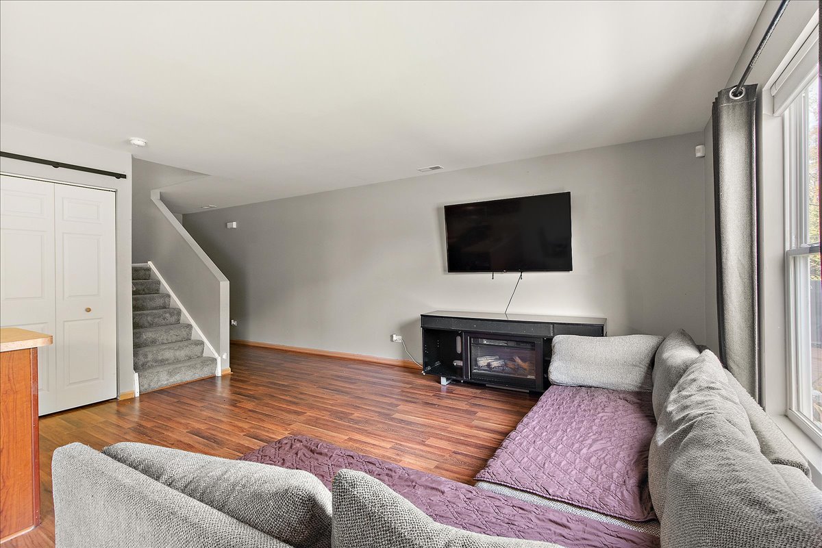 25273 Faraday Road Manhattan, IL 60442 - Photo 6 of 20 a living room with furniture and a flat screen tv