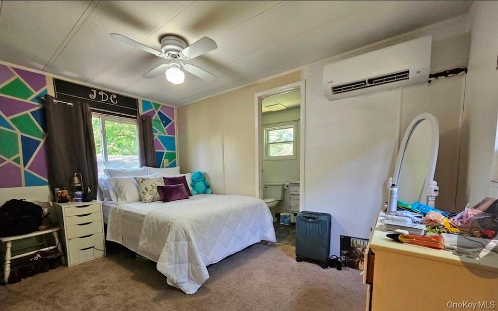 57 Sheafe Road Wappingers Falls, NY 12601 - Photo 18 of 20 Carpeted bedroom featuring a ceiling fan with integrated lighting, a window, and an air conditioning unit