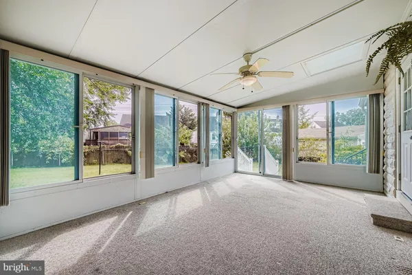 a view of an empty room with windows and city view