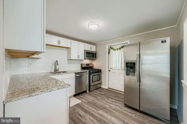 a kitchen with a refrigerator and a sink