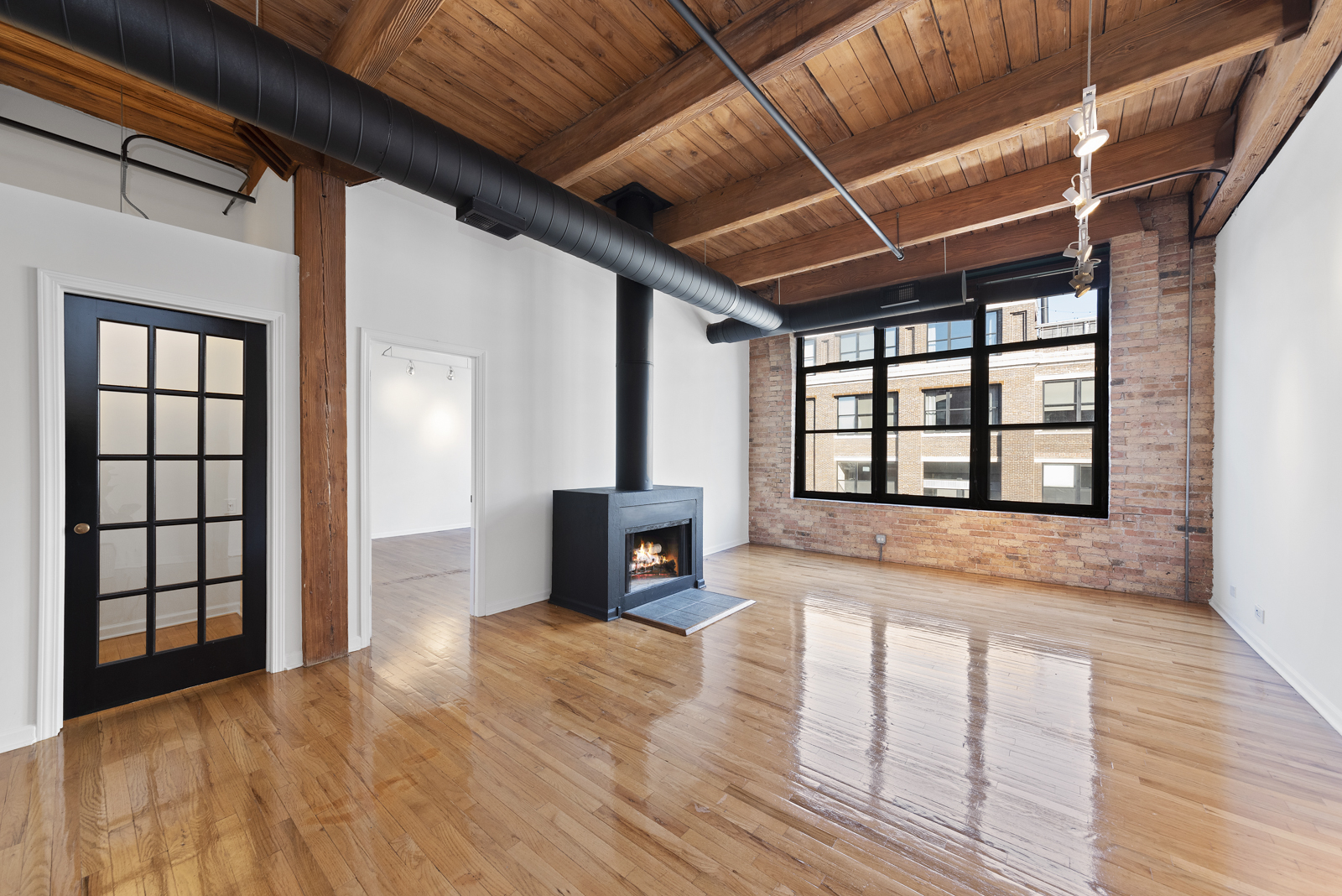 1017 West Washington Boulevard, Unit 5B Chicago, IL 60607 - Photo 2 of 13 a view of an empty room with a window and wooden floor