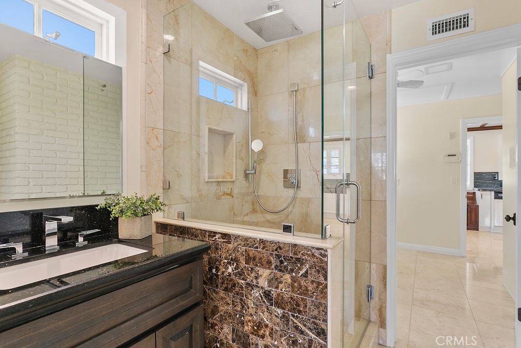 9631 Fleet Road Villa Park, CA 92861 - Photo 26 of 64 a bathroom with a granite countertop shower a sink and a mirror