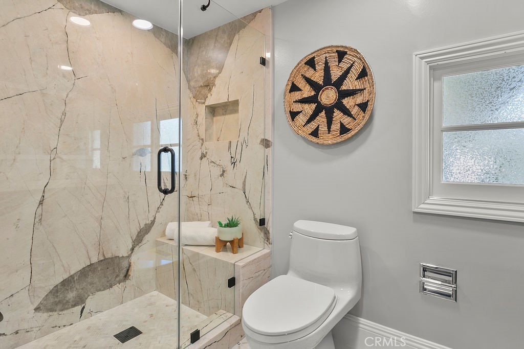 9631 Fleet Road Villa Park, CA 92861 - Photo 36 of 64 a white toilet sitting next to a bathroom sink