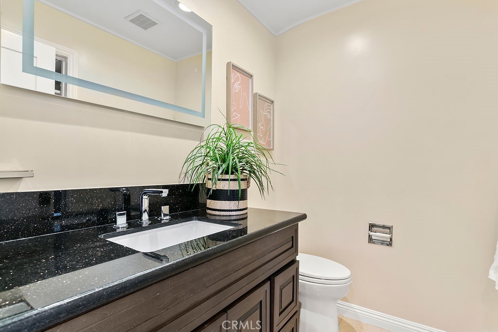 9631 Fleet Road Villa Park, CA 92861 - Photo 38 of 64 a bathroom with a granite countertop sink and a mirror