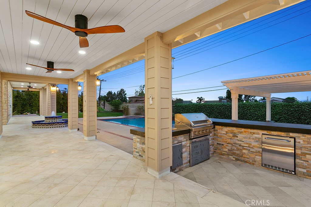 9631 Fleet Road Villa Park, CA 92861 - Photo 51 of 64 a view of a patio with a table and chairs and floor to ceiling window