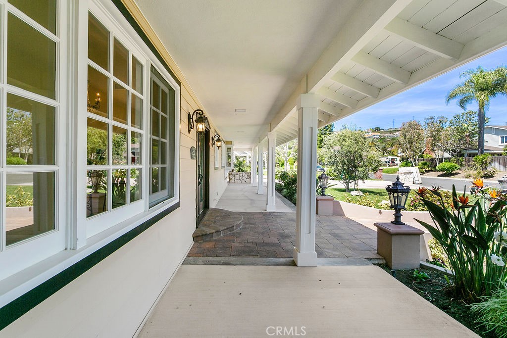 9631 Fleet Road Villa Park, CA 92861 - Photo 7 of 64 a view of a porch with a floor to ceiling window and potted plants