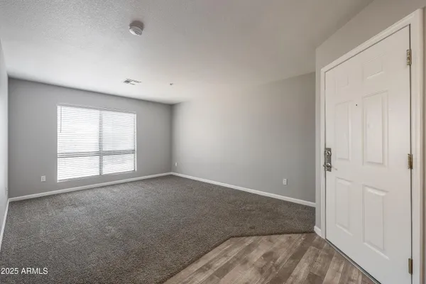 an empty room with a empty space and a window