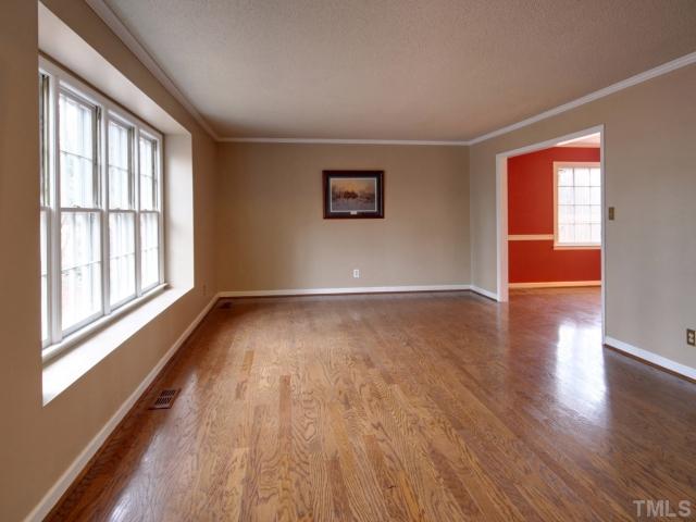 8704 Oneal Road Raleigh, NC 27613 - Photo 2 of 12 Large formal living room with crown moulding that can handle any size furniture. Large window overlooking front yard. Neutral paint color. Entertaining is a breeze with this room. Plently of natural light. Custom painting.