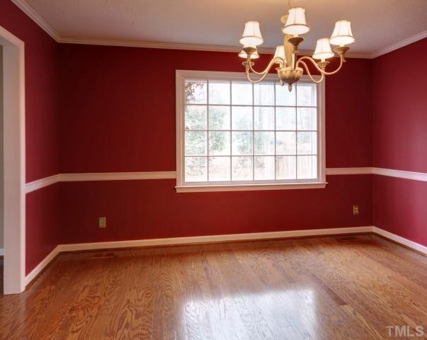 8704 Oneal Road Raleigh, NC 27613 - Photo 3 of 12 Formal dining room with crown moulding and chair railing. Enjoy family dinners or entertaining guests in this spacious room. Direct access to kitchen. Custom paint.