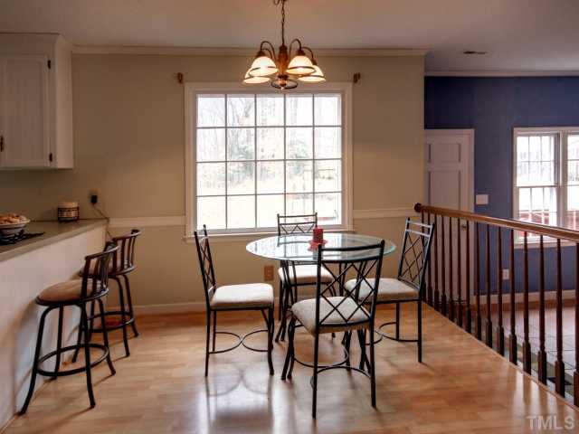 8704 Oneal Road Raleigh, NC 27613 - Photo 5 of 12 Breakfast area overlooking the huge back yard. Hardwood floors in breakfast nook as well. Pull up to the bar for a quick bite to eat. Overlook the large family room addition- adds additional heated square footage!!!