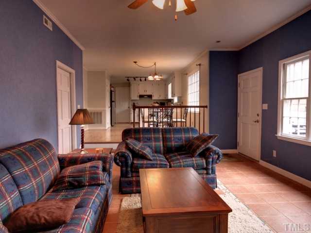 8704 Oneal Road Raleigh, NC 27613 - Photo 6 of 12 Step down into this family room. Fireplace with brick wall surround. Tile flooring makes for easy clean floor! Access to patio for outdoor entertaining.