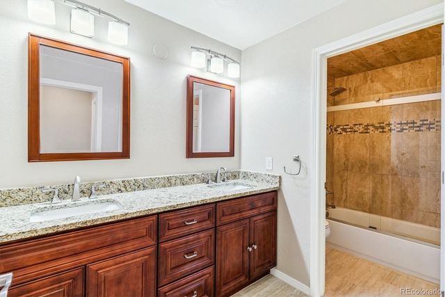 a bathroom with a granite countertop sink mirror and double