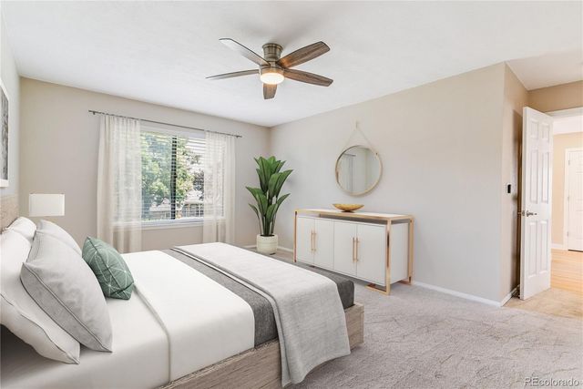 a bedroom with a large bed and a window