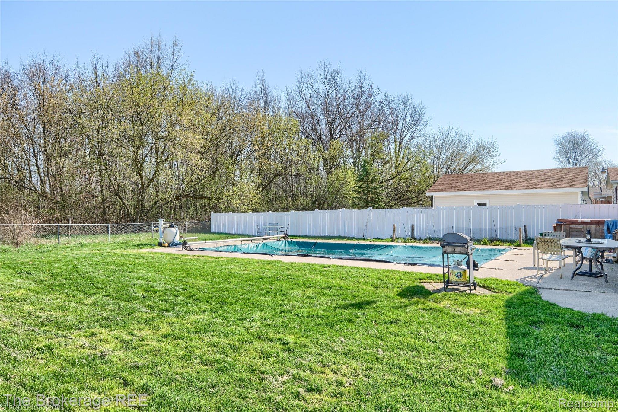 5477 Hopkins Road Flint, MI 48506 - Photo 24 of 27 View of swimming pool featuring patio surround, a fenced backyard, and area for grilling