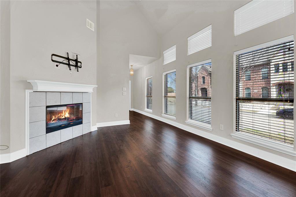 2010 Downing Street Allen, TX 75013 - Photo 12 of 29 a view of an empty room with wooden floor fireplace and a window