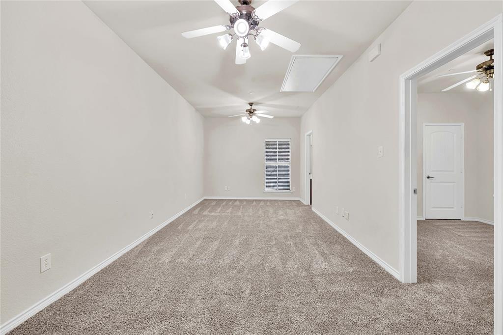 2010 Downing Street Allen, TX 75013 - Photo 16 of 29 an empty room with chandelier fan and windows