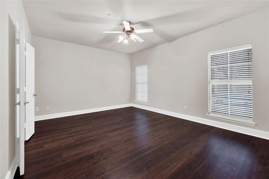 2010 Downing Street Allen, TX 75013 - Photo 2 of 29 an empty room with wooden floor and windows