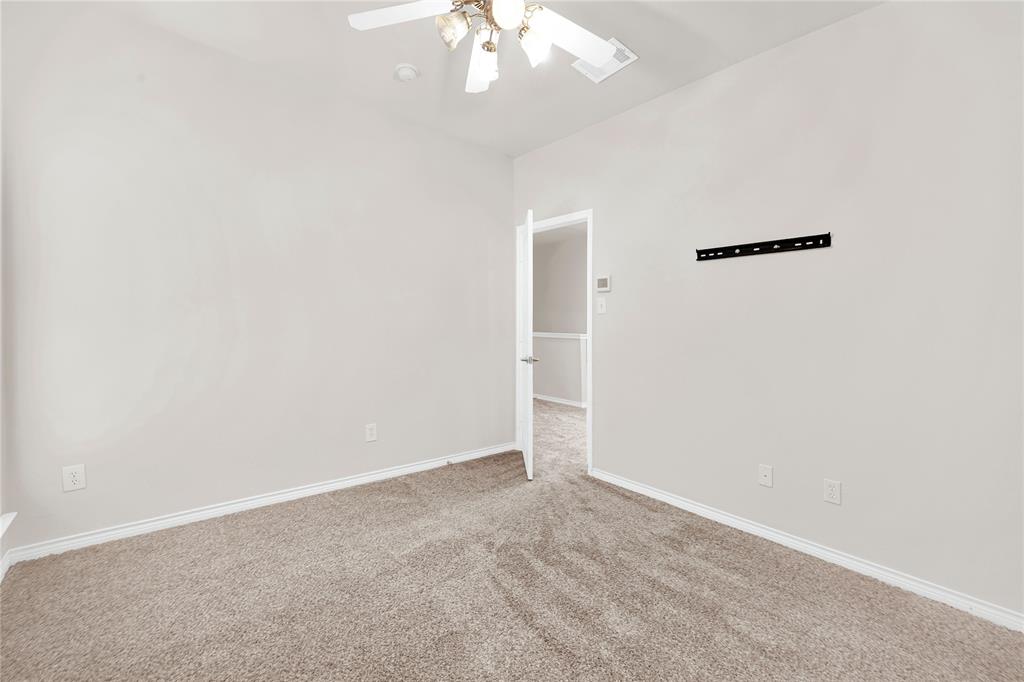 2010 Downing Street Allen, TX 75013 - Photo 21 of 29 an empty room with a chandelier fan