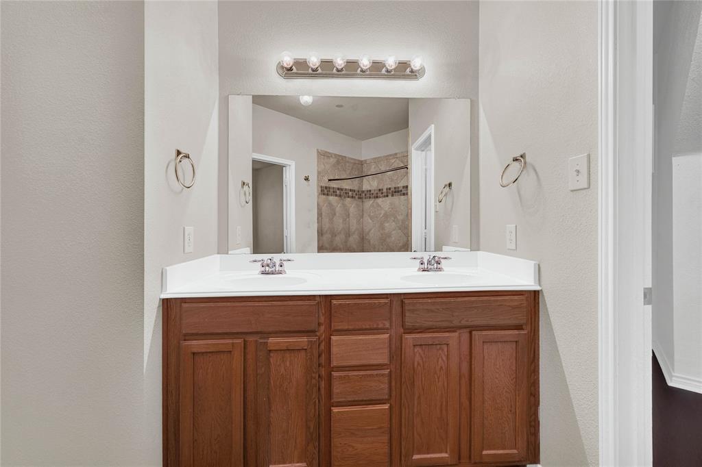 2010 Downing Street Allen, TX 75013 - Photo 4 of 29 a bathroom with a granite countertop sink and a mirror