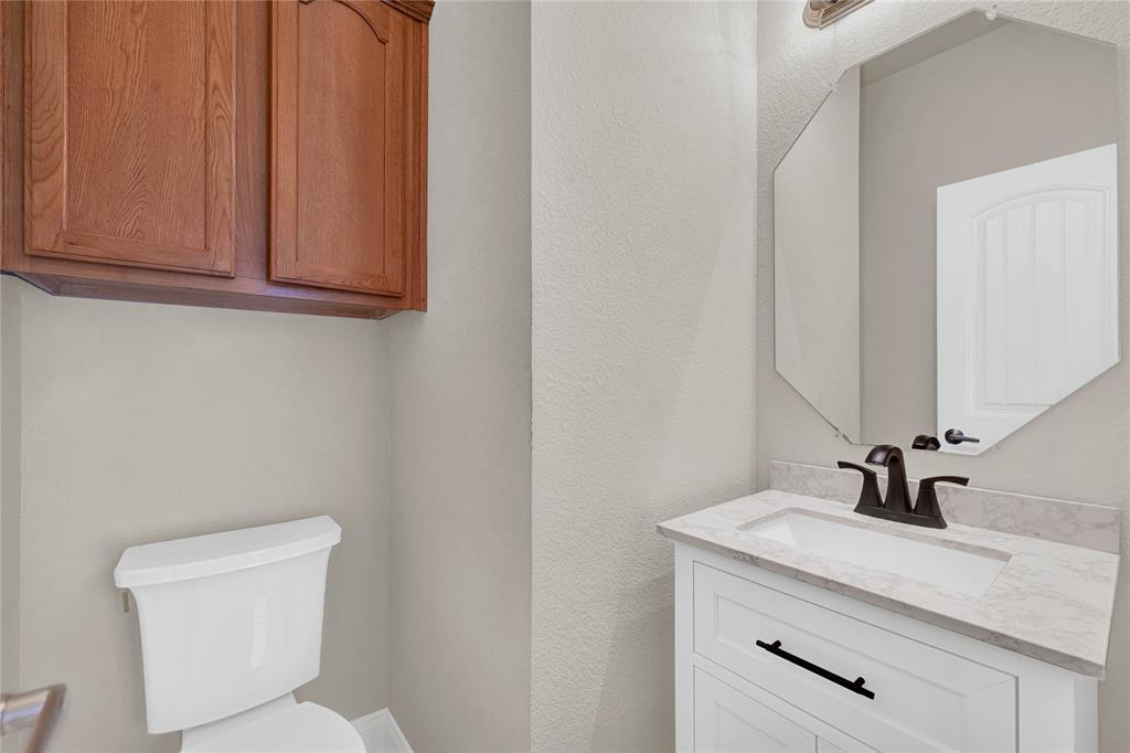 2010 Downing Street Allen, TX 75013 - Photo 7 of 29 a bathroom with a toilet sink and mirror