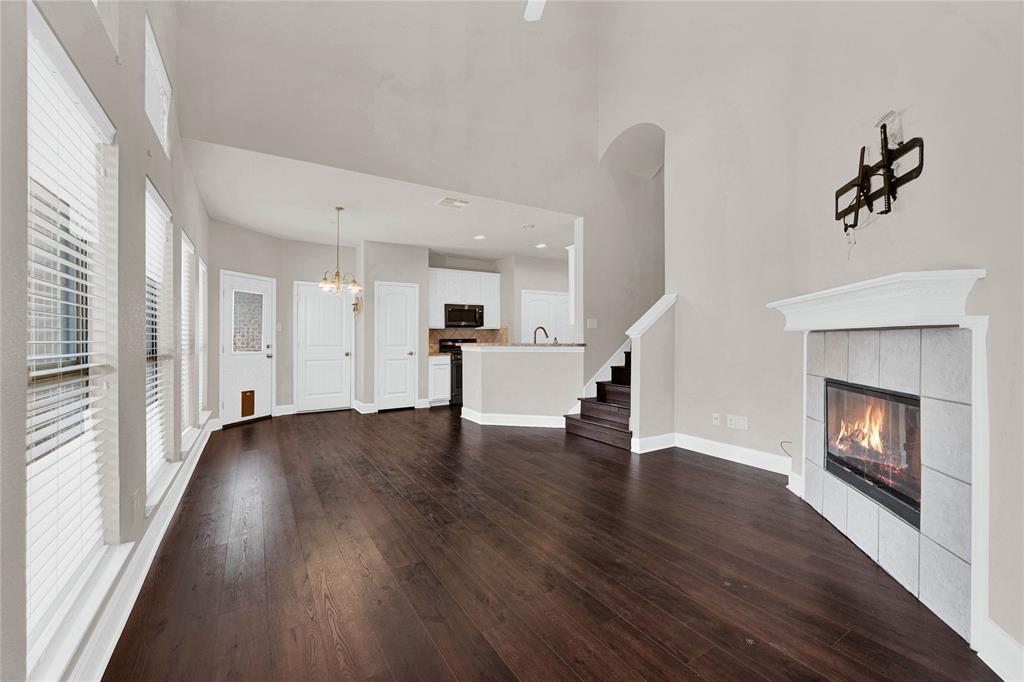 2010 Downing Street Allen, TX 75013 - Photo 9 of 29 a view of an empty room with wooden floor and a fireplace