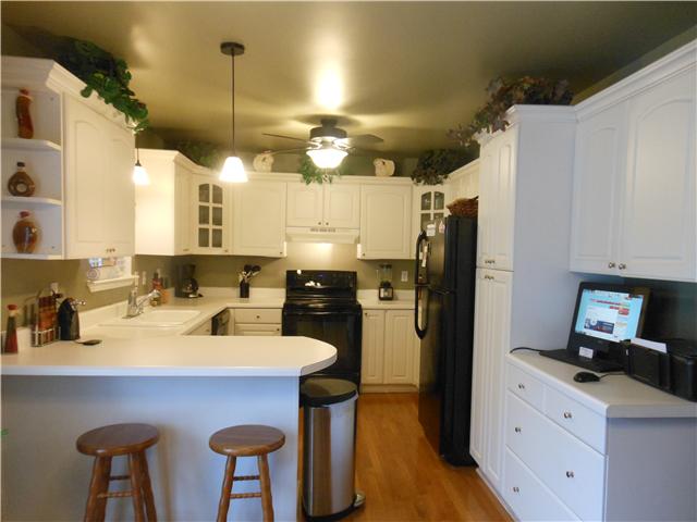 1898 Rock Church Road Charlotte, TN 37036 - Photo 5 of 16 Nice open kitchen with pantry, bar stool area, dishwasher, refrigerator and stove/oven
