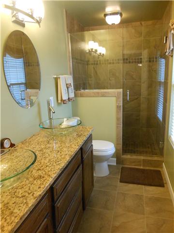 1898 Rock Church Road Charlotte, TN 37036 - Photo 10 of 16 Gorgeous remodeled master bath with tiled floor, tiled shower and double vanity