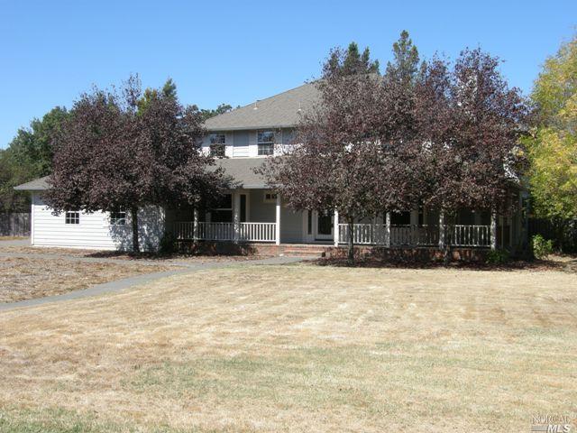 140 Oak Tree Drive Santa Rosa, CA 95401 - Photo 1 of 1 a front view of a house with a yard and garage