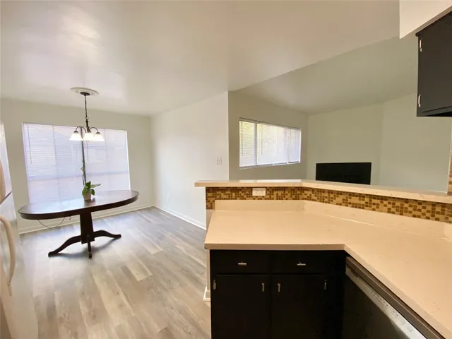 a view of a kitchen with a sink stainless steel appliances and cabinets