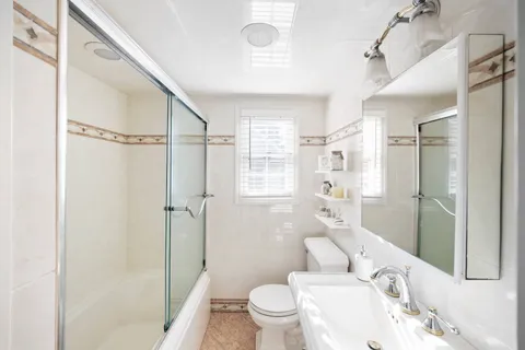 a large bed sitting in a bedroom next to a window