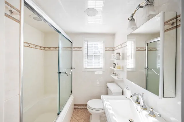 a large bed sitting in a bedroom next to a window