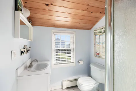 a bedroom with bed and flat screen tv