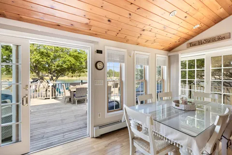 a dining room with furniture and wooden floor