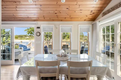 a view of a hallway with furniture and wooden floor