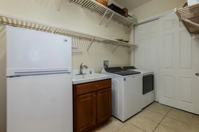 a utility room with cabinets washer and dryer
