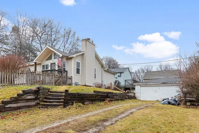 a view of a house with swimming pool and sitting area