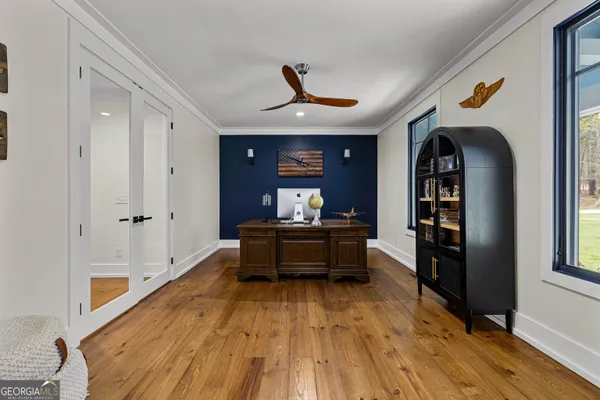 a view of an empty room with wooden floor