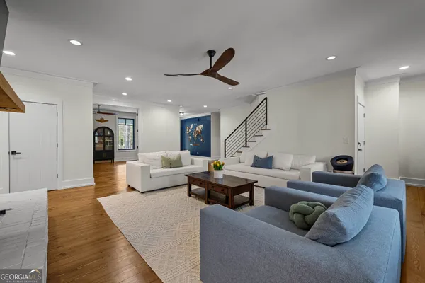 a living room with furniture and wooden floor