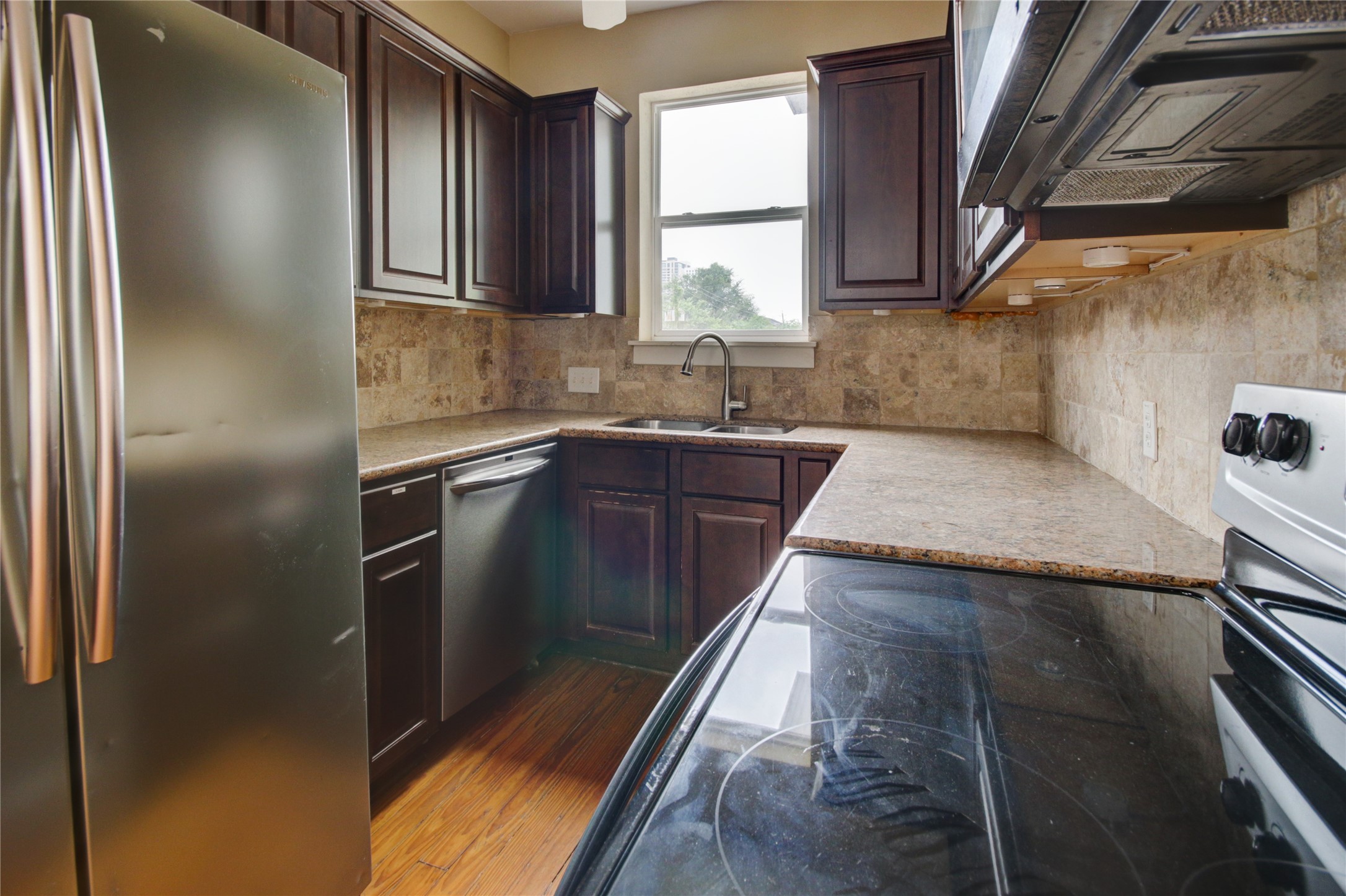 239 Westheimer Road Houston, TX 77006 - Photo 29 of 50 SECOND FLOOR:Additional view of the kitchen with ornate backsplash and stainless steel appliances that add a sophisticated flair to the well-positioned kitchen.