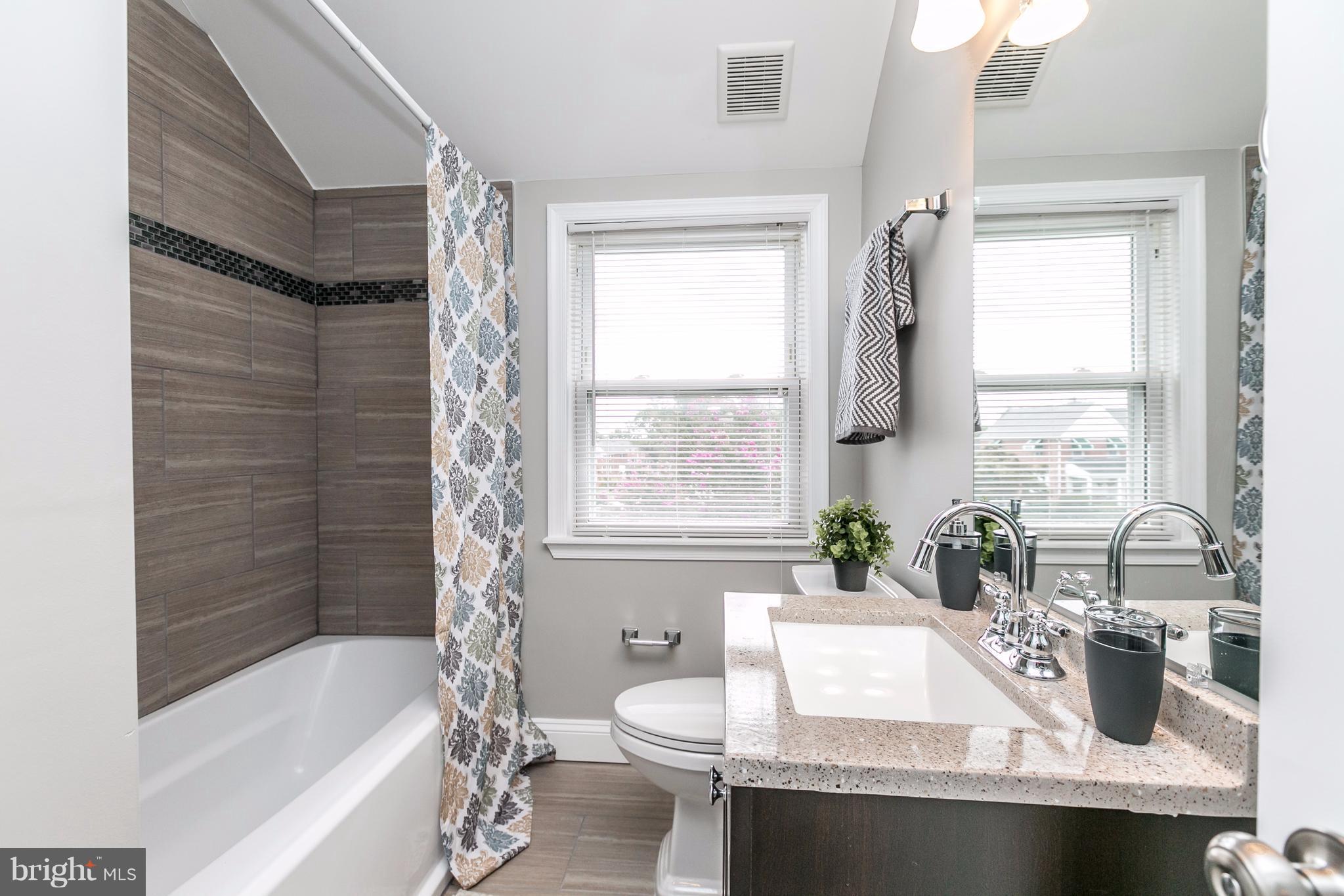 4674 Marble Hall Road Baltimore, MD 21239 - Photo 14 of 29 a bathroom with a granite countertop sink mirror bathtub and next to a window